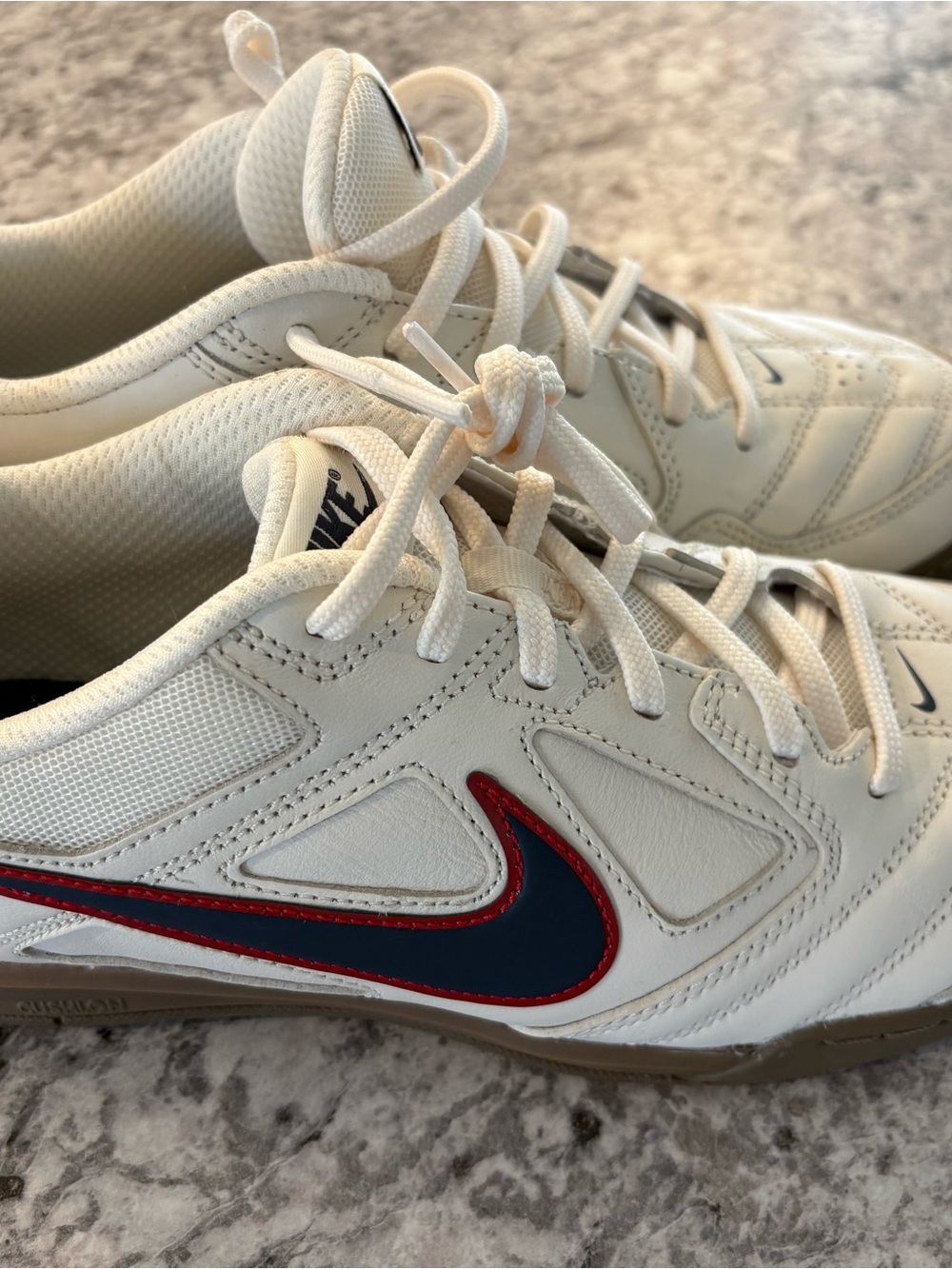 NWOT or box. Nike Men’s Cream/Blue Sneakers with Red Accent